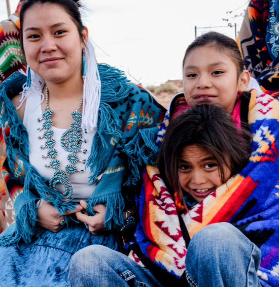Native American family poses for a photo.