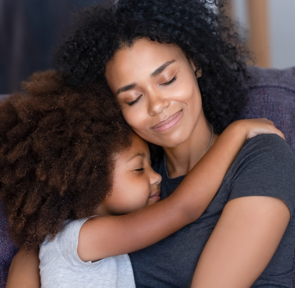 smiling mother embracing happy child